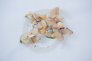 Colored pencils shavings on a white background