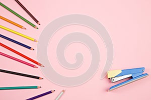 Colored pencils and stationery on pink isolated background. top view. flat lay. mockup