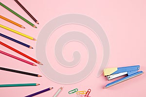 Colored pencils and stationery on pink isolated background. top view. flat lay. mockup