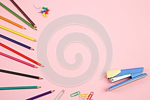 Colored pencils and stationery on pink isolated background. top view. flat lay. mockup