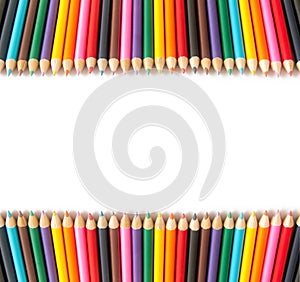 Colored pencils in two rows on a white background