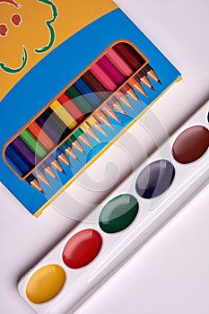 Colored pencils watercolor paint palette on a white background