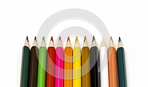 Colored pencils on a white background. Education concept. Focus on sharpened pencils.