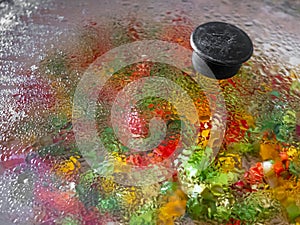 Colored peppers blurred by condensation on a glass top