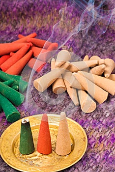 Colored and perfumed incense cones burning