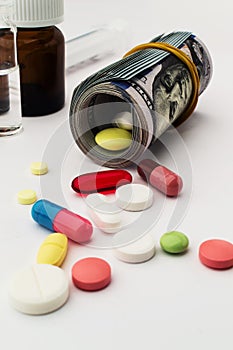 Colored pills with money. Health costs a lot