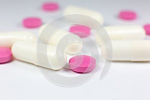 Colored pills on white background. Close up. Medical treatment concept