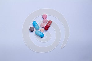 Colored pills on a white background. Medicines or legal drugs for human consumption