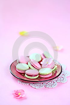 Colored pink and green Macarons with Raspberry Cream Filling