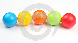 Colored plastic balls on white background