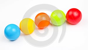 Colored plastic balls on white background