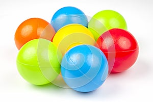 Colored plastic balls on white background