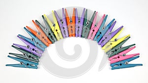 Colored plastic clothespins for clothes on a white background
