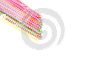 Colored plastic drinking straws on a white background