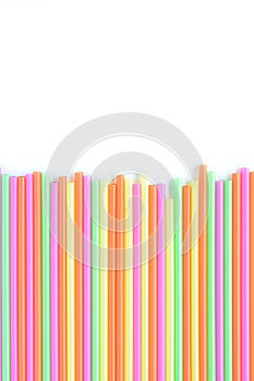 Colored plastic drinking straws on a white background