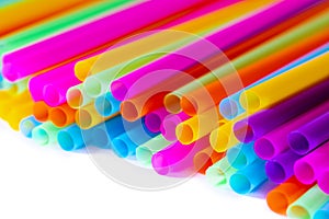 Colored plastic drinking straws on a white background