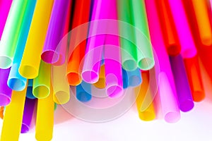 Colored plastic drinking straws on a white background