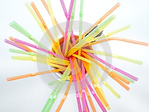 Colored plastic drinking straws on a white background