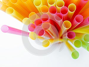 Colored plastic drinking straws on a white background