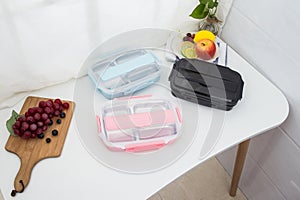 Colored plastic lunchboxes on the table