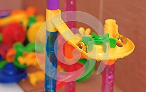 Colored plastic piece designer slide for balls in the bathroom.