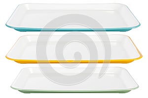 Colored plastic platters on white background