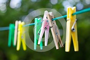 Colored plastic and wooden clothes pegs