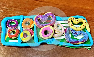 Colored plasticine doughnuts and pretzels
