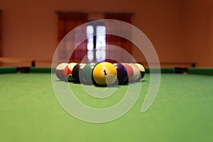 Colored pool balls on a green pool table. Billiard ball with number one