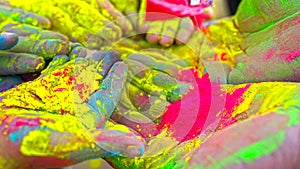 Colored powder fired up.Human hands ready to play Holi. Good fun on color festival