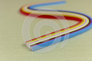 Colored quilling paper on a light background. Abstract background texture