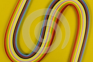 Colored quilling paper on a yellow background. Abstract background texture