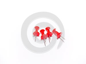 Colored red push pins isolated on white background.Studio shot