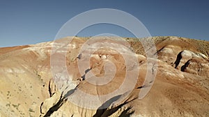 Colored rocks . Flying over red rock formation in Southern mountains. Aerial shot, 4K