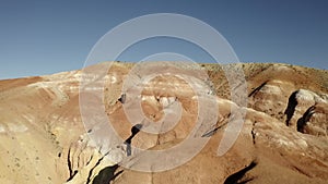 Colored rocks . Flying over red rock formation in Southern mountains. Aerial shot, 4K