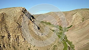 Colored rocks . Flying over red rock formation in Southern mountains. Aerial shot, 4K.