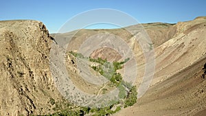 Colored rocks . Flying over red rock formation in Southern mountains. Aerial shot, 4K.