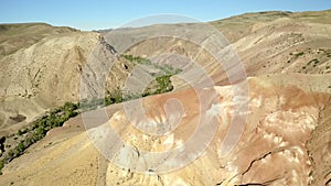 Colored rocks . Flying over red rock formation in Southern mountains. Aerial shot, 4K.