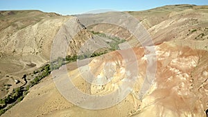 Colored rocks . Flying over red rock formation in Southern mountains. Aerial shot, 4K.