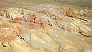 Colored rocks . Flying over red rock formation in Southern mountains. Aerial shot, 4K.