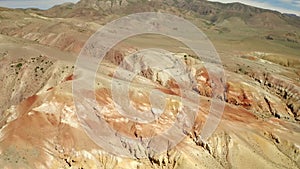 Colored rocks. Flying over red rock formation in Southern mountains. Aerial shot, 4K.