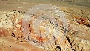 Colored rocks. Flying over red rock formation in Southern mountains. Aerial shot, 4K.