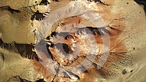 Colored rocks . Martian landscape. Flying over red rock formation in Southern mountains. Aerial shot, 4K.