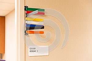 Colored Signals on door of patient exam room, in medical clinic