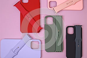 Colored silicone phone cases, complete with watch strap. Set. Up to date technology.Close up of diverse personal accessory laying