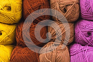 Colored skeins of wool on a store shelf. Woolen skeins for knitting all the colors of the rainbow, brown, yellow, red and purple