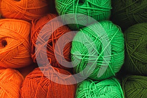 Colored skeins of wool on a store shelf. Woolen skeins for knitting all the colors of the rainbow, green, brown, red and orange