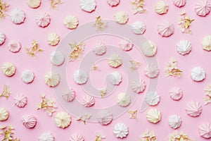 Colored small meringues on a pink background. Flat lay concept. Copy space