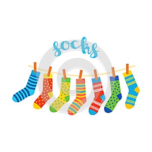 Colored socks hanging on a rope on white background