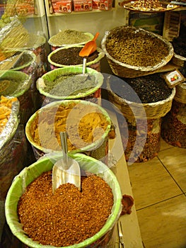 Colored spices exposed in wicker baskets in a shop in Turkey.